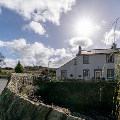 Stay in a character cottage right next to the little River Eea