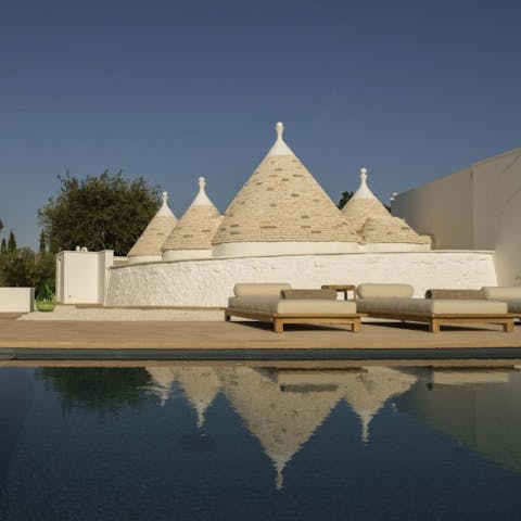 Admire the traditional Trulli cones from the cool of the infinity pool