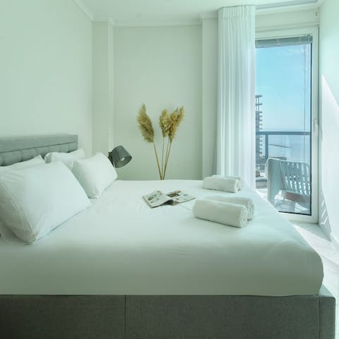 Wake up to sea views each day in the sleek bedroom