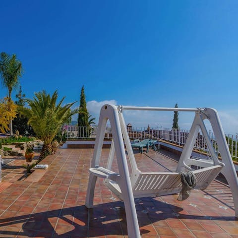 Read a book in the swinging chair and while away the sun-soaked hours