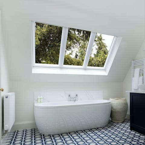 Luxuriate under the skylight in the elegant standalone bathtub