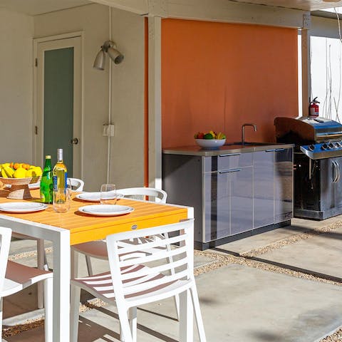 Barbecue to your heart's content in the outdoor kitchen and dine alfresco on the covered poolside terrace