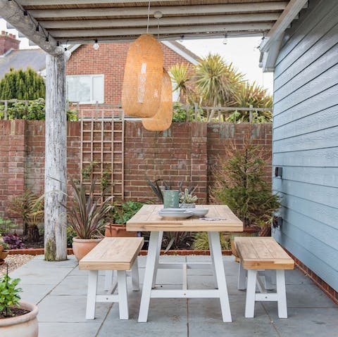 Share a meal and a bottle of wine in the courtyard