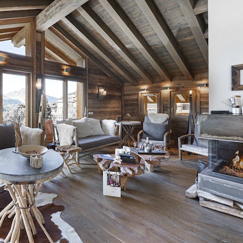 Convene in the cozy living room and drink coffee by the fire