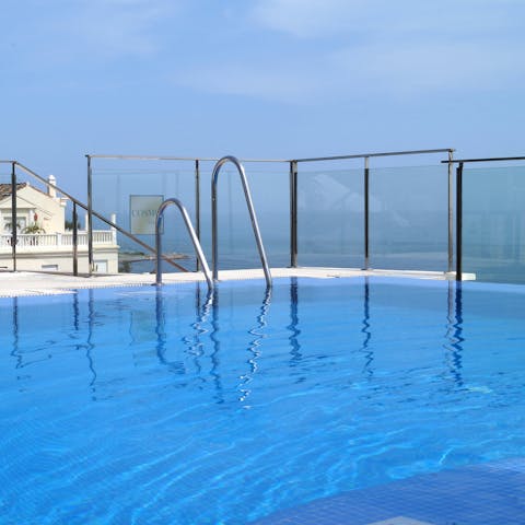 Take a dip in one of the apartment building's swimming pools and delight in the sea views