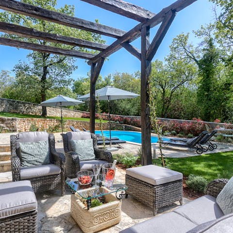 Share bottles of wine and champagne on the cute cushions under the pergola 