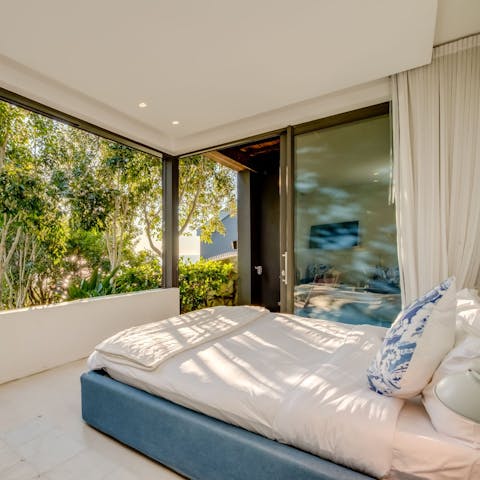 Wake up to the sight of swaying palm trees and ocean waves in the main bedroom