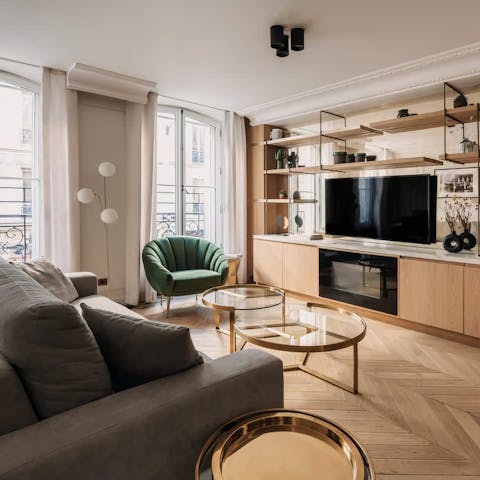 Relax in the bright living room with a glass of French wine after a day of exploring the city