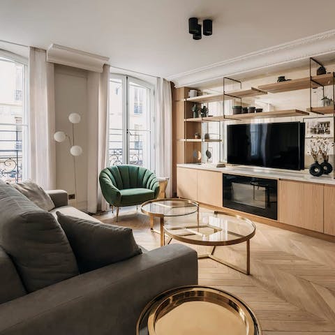 Relax in the bright living room with a glass of French wine after a day of exploring the city