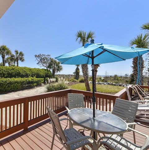 Gather around for a refreshment while the kids play in the private sand backyard