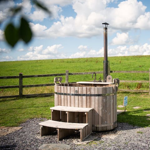 Unwind in the wood-fired hot tub while admiring the countryside views