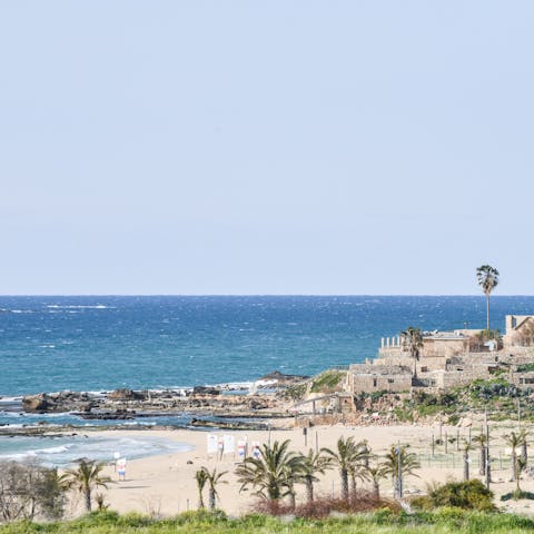 Make the ten-minute walk to Akhziv Beach to paddle in the crystal clear sea
