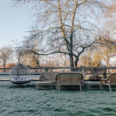 Relax on the garden furniture surrounded by acres of countryside fields 
