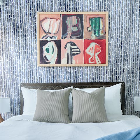Relax in the comfy bedroom with its modern art prints after a busy day in Minneapolis 