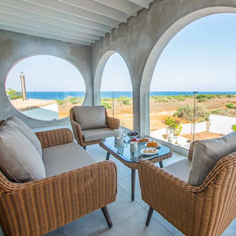 Enjoy a drink with a view on the covered balcony
