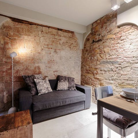 Settle on to the sofa among exposed-brick walls
