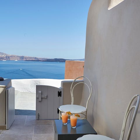 Enjoy breakfast on the balcony overlooking the Aegean Sea