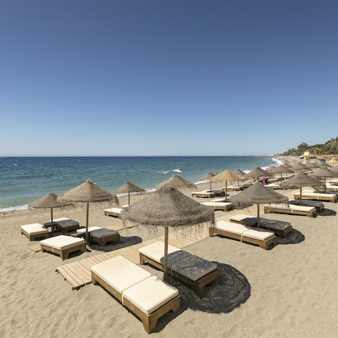 Doze off beneath the palapa parasols on Playa Casablanca, a short walk away