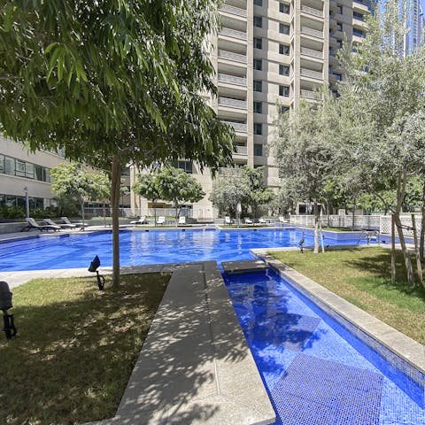 Chill out or cool off in the communal, outdoor pool surrounded by lush greenery