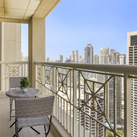 Sip on your morning cup of coffee on the balcony while enjoying stunning skyscraper views