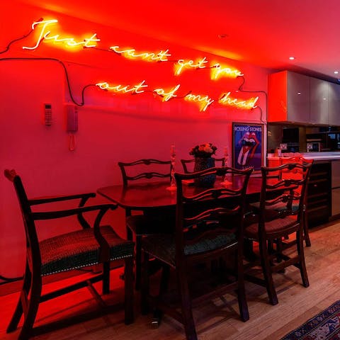 Make up a jug of cocktails and drink at the dining set under the funky neon sign