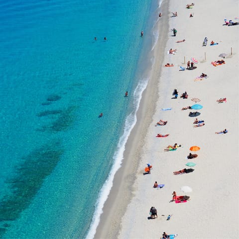 Spend the day at Plaka Beach, a short drive from the villa