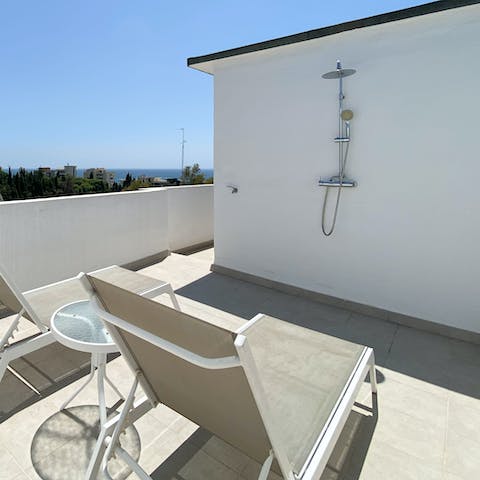 Cool off beneath the outdoor shower of the private sun deck 