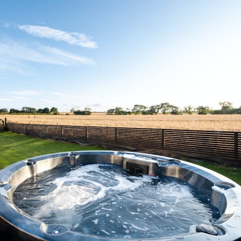 Enjoy a glass of wine and relax in the bubbling hot tub, taking in your wild surroundings