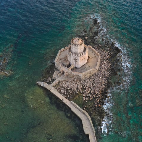 Visit the medieval castle by the nearby village of Methoni