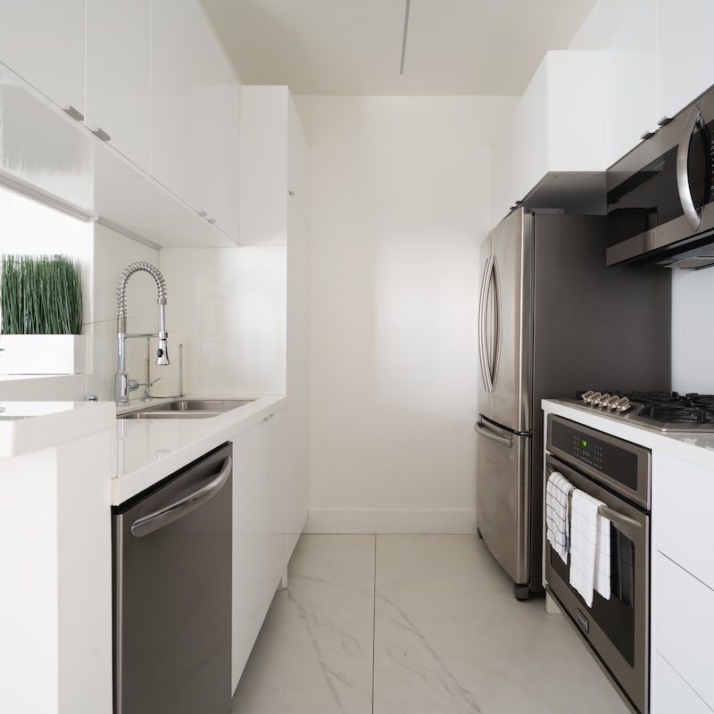 Knock up a lazy brunch in the sleek kitchen with marble floors