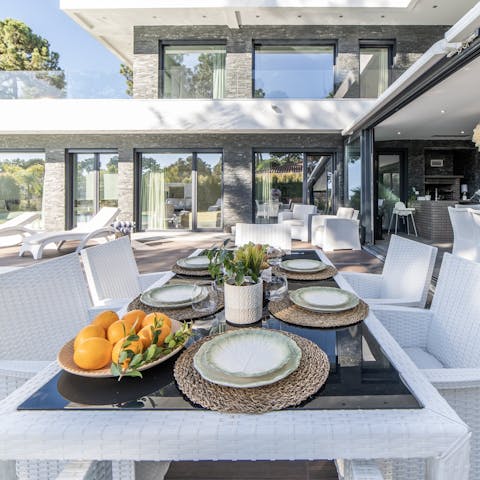 Dine alfresco in the outdoor dining area by the pool
