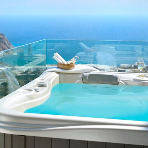 Relax in the bubbly jacuzzi accompanied by stunning sea views