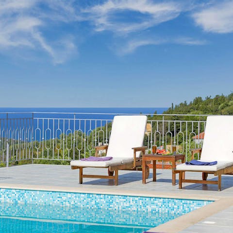 Lounge by the pool and admire the sea vistas