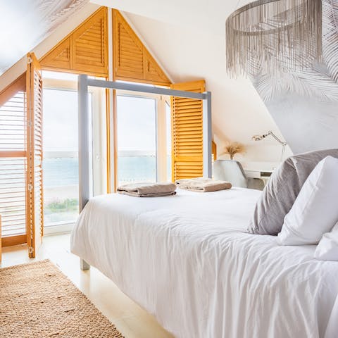 Wake up in the four-poster bed to the sound of the waves lapping the shore
