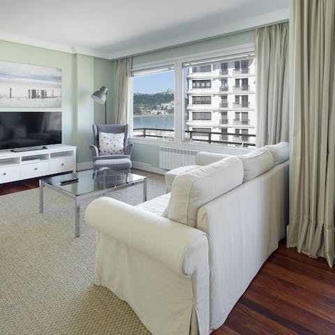 Look out to views of La Concha Bay from the living room's sofa
