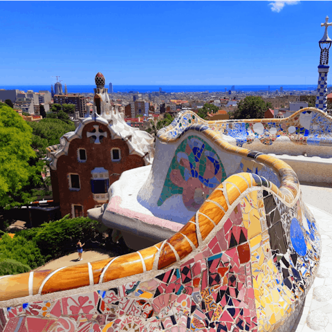 Visit Park Güell with its iconic benches and views
