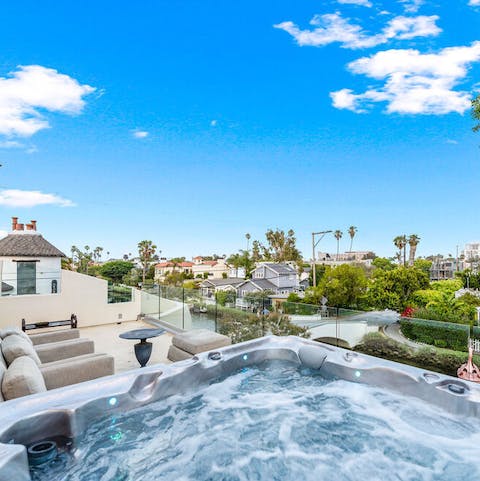 Slide into the hot tub on the first floor terrace and take in views of the canals