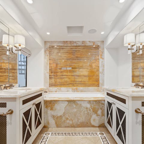 Soak your stresses away in the marble bath in the master bathroom