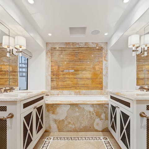 Soak your stresses away in the marble bath in the master bathroom