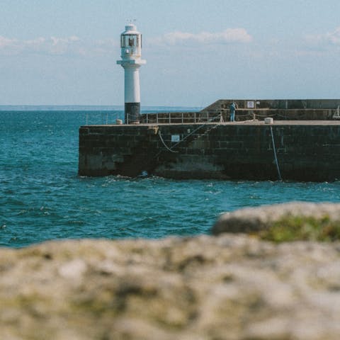 Explore the historic port of Penzance on the shores of Mount's Bay, a six-minute drive from this home