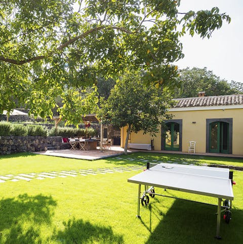 Play table tennis in the sun-soaked garden