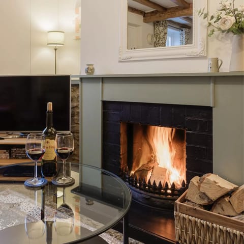 Cosy up with a glass of wine in front of the fire