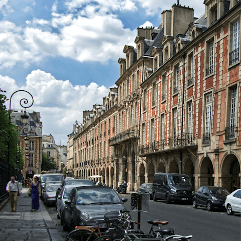 Have a picnic at historic Place des Vosges, an eighteen-minute walk from home
