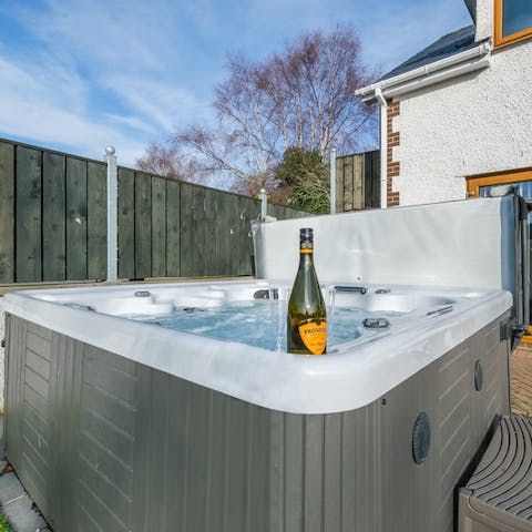 Unwind under the sunset in the hot tub with a bottle of bubbly