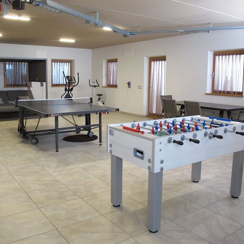 Enjoy a round of table tennis and table football in the games room