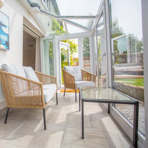 Take in views of the garden's stream from the sunny conservatory