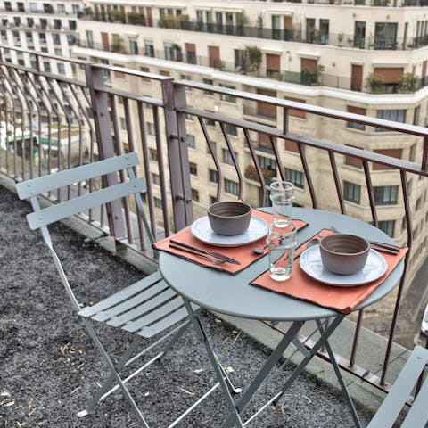 Enjoy local Parisian pastries on the balcony while listening to the city come alive