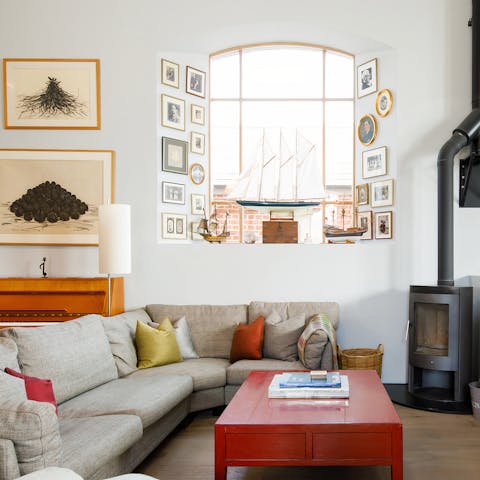 Cosy up on the L-shaped sofa in front of the log burner