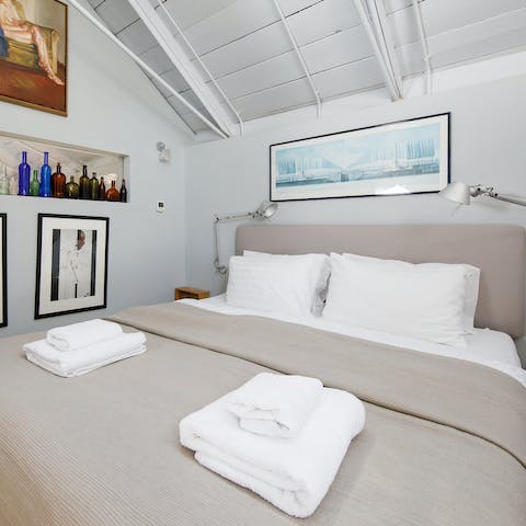 Get some rest in the stylish master bedroom after exploring Chichester