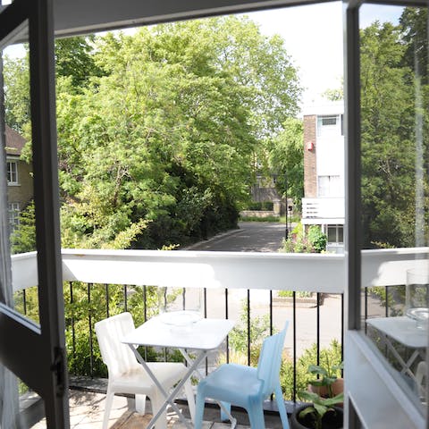 Enjoy an evening tipple on the balcony overlooking the leafy street